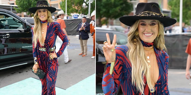 Lainey Wilson flashes a peace sign before walking the red carpet at CMT Music Awards.