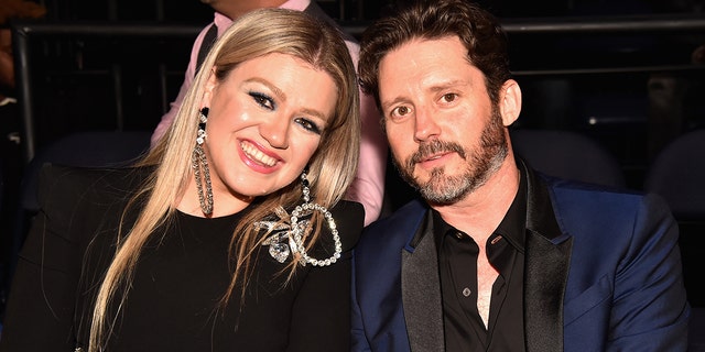 Kelly Clarkson and Brandon Blackstock smile in happier times.