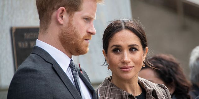 Prince Harry and Meghan Markle look serious in a photo