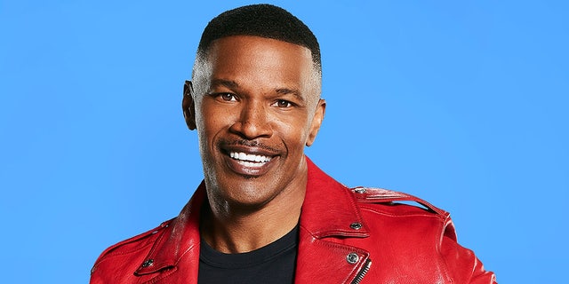Jamie Foxx wears red leather jacket and black shirt for portrait