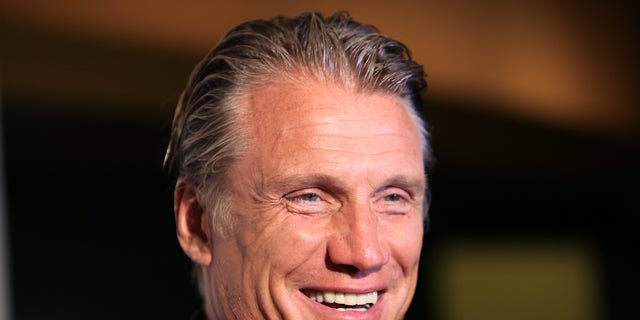 Dolph Lundgren smiles for a photo.