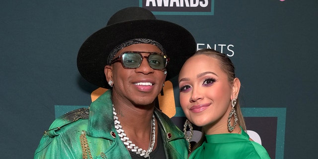 Jimmie Allen smiling with his wife
