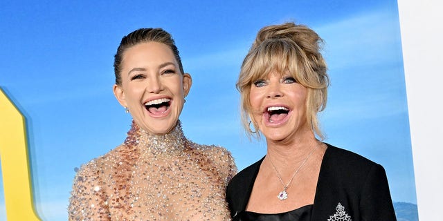 Goldie Hawn and Kate Hudson laugh while on red carpet at movie premiere
