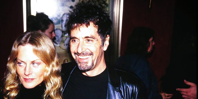 Beverly D'Angelo and Al Pacino walk arm in arm together at a film premiere