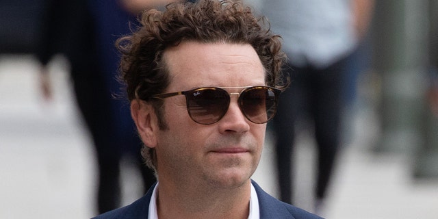 Danny Masterson wears a blue suit and sunglasses while arriving to court for rape trial in LA