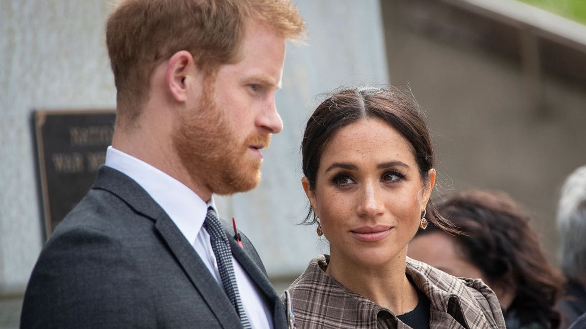 Prince Harry and Meghan Markle look serious in a photo