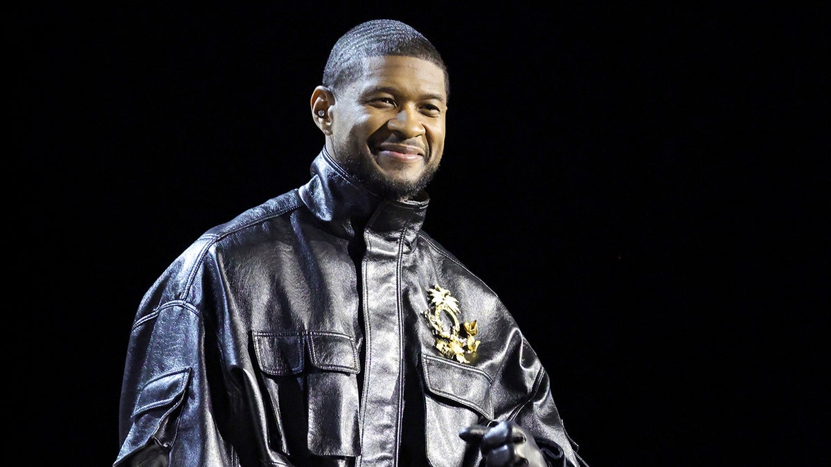 Usher smiling at the Super Bowl Halftime Show press conference