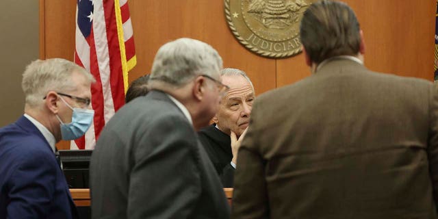 Judge Kent Holmberg talks with attorneys during the trial in Park City, Utah.