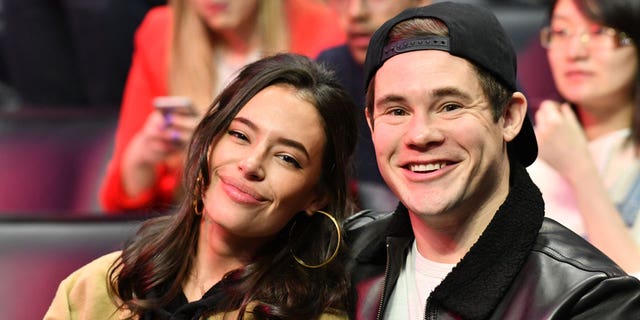 Adam DeVine and his wife attend a sports game