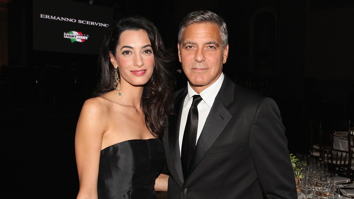 Amal Clooney and George Clooney posing together