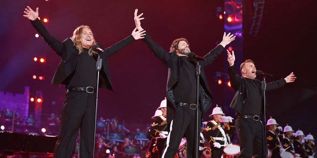 Gary Barlow, Howard Donald and Mark Owen of Take That perform on stage during the Coronation Concert