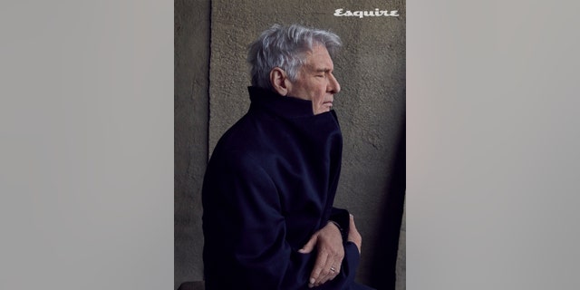 Harrison Ford wearing a jacket, closing his eyes in a photo for Esquire