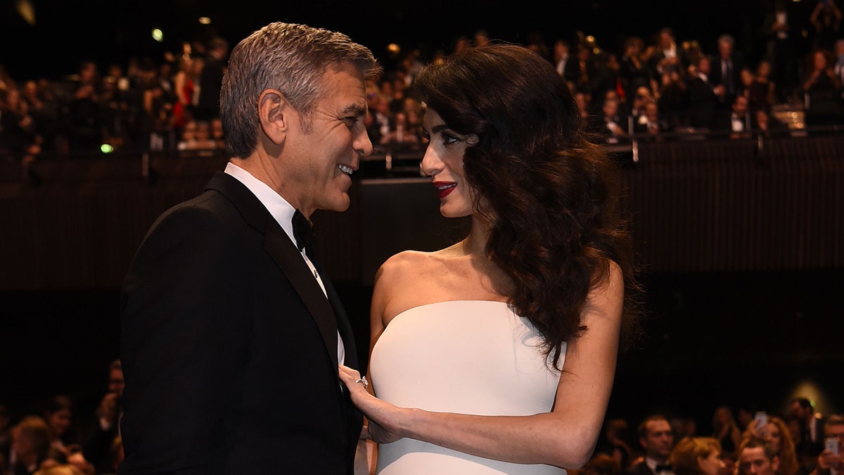 George Clooney smiling at Amal Clooney