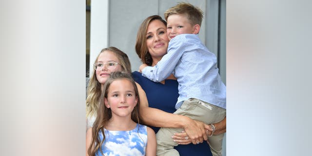 Jennifer Garner holds son Samuel with daughters Violet and Seraphina Affleck nearby.