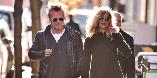 John Mellencamp and Meg Ryan hold hands wearing sunglasses while in New York City in 2018