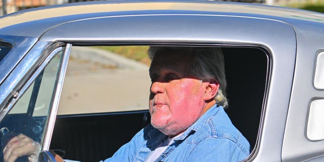 Jay Leno drives classic car after being released from hospital for face burns