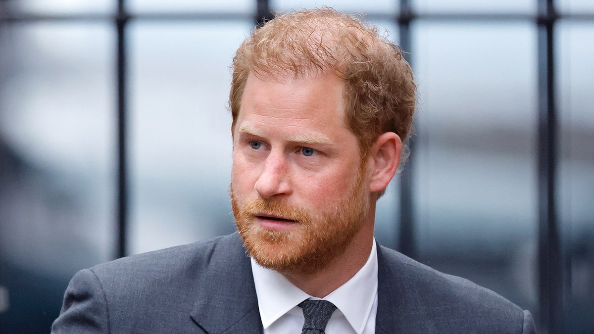 A close-up of Prince Harry in a grey suit