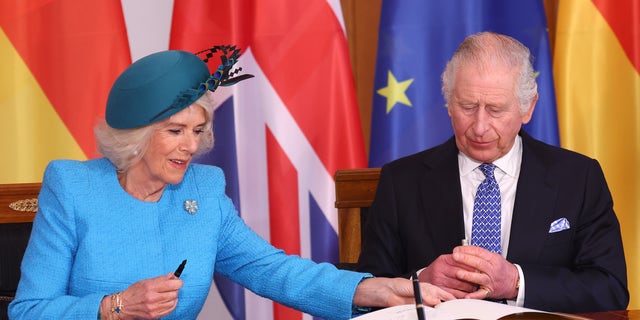 King Charles and Camilla both signed the guestbook in the presence of Germany's president and his wife.