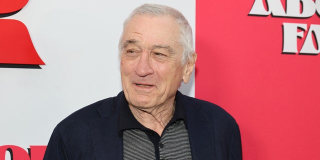 Robert De NIro looks off to his right and smiles while in New York City for the premiere of his film "About My Father"
