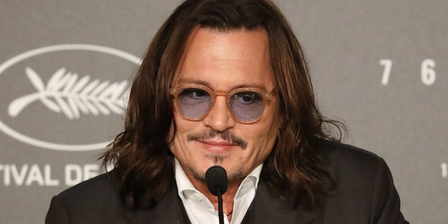 Johnny Depp wearing sunglasses at the Jeanne du Barry press conference