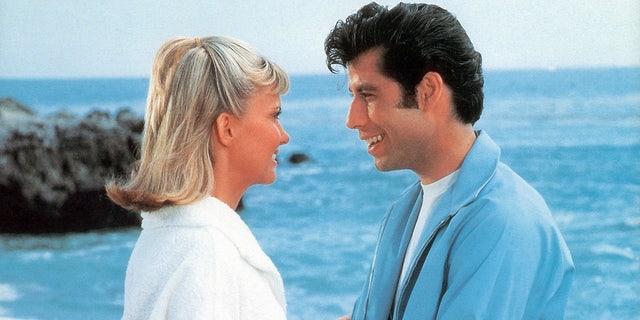 Olivia Newton-John and John Travolta on the beach while filmnig "Grease"