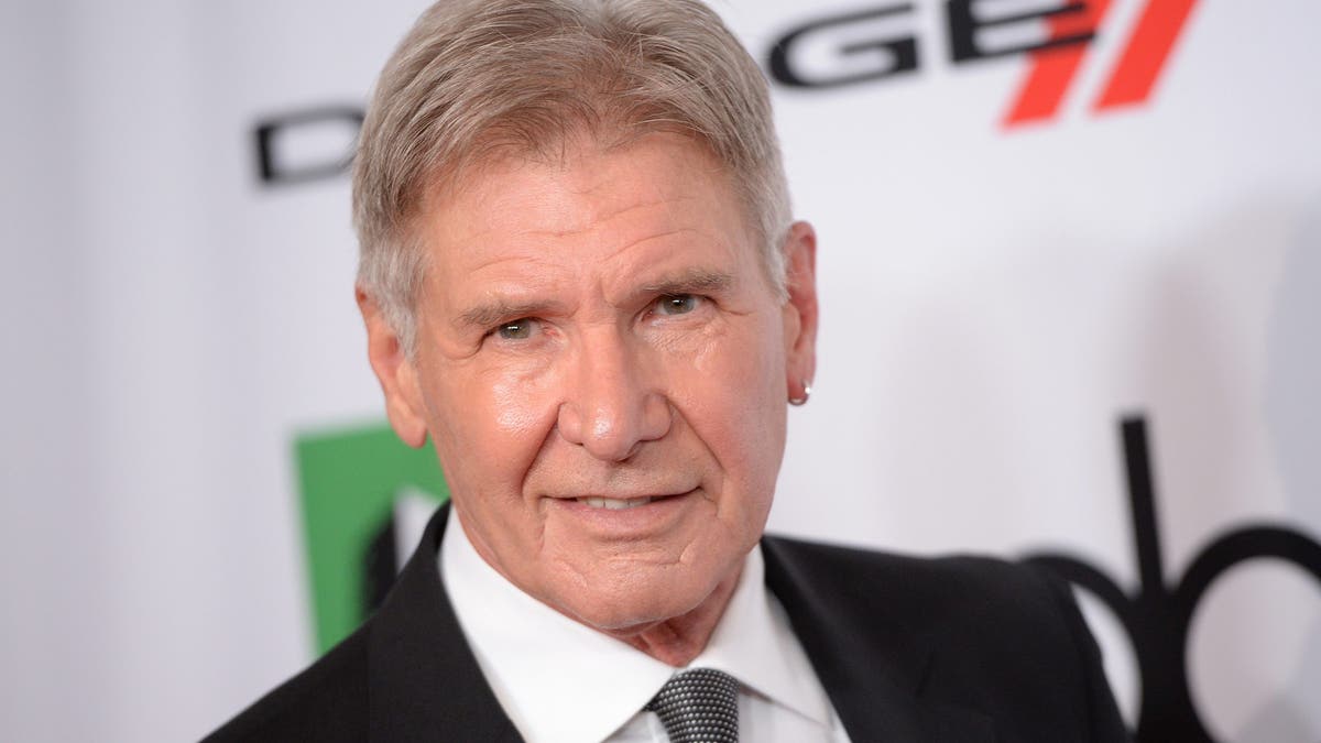 harrison ford on red carpet with hoop earring