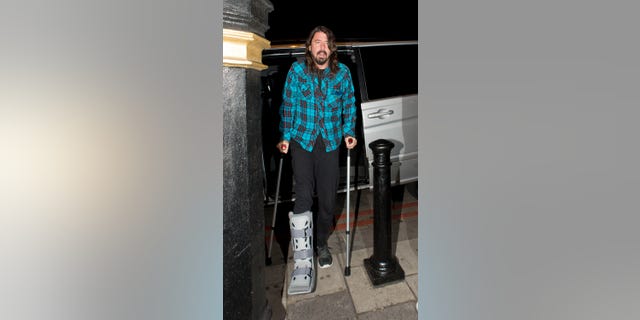 Dave Grohl walking with crutches