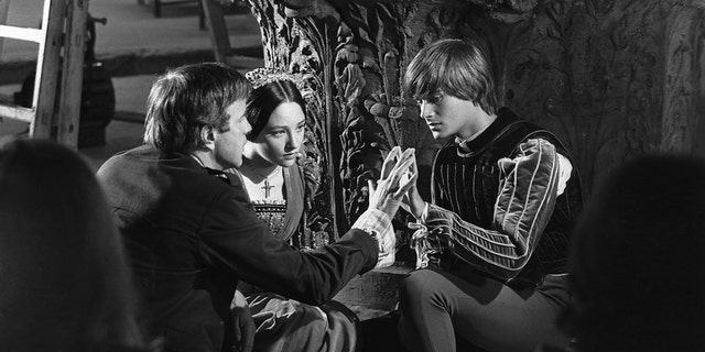 A behind the scenes photo of Olivia Hussey and Leonard Whiting being directed in "Romeo and Juliet."