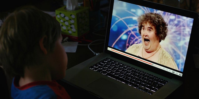 A little boy watches on his computer Susan Boyle who sings out on "Britain's Got Talent"