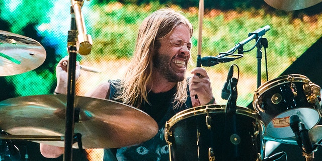 With his eyes closed Taylor Hawkins passionately plays the drums on stage