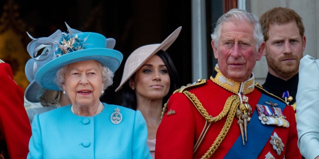 Queen Elizabeth II, King Charles III, Prince Harry, and Meghan Markle stand on the balcony for the Trooping of the Colour 2019