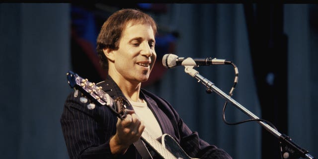 Paul Simon performing onstage in 1980