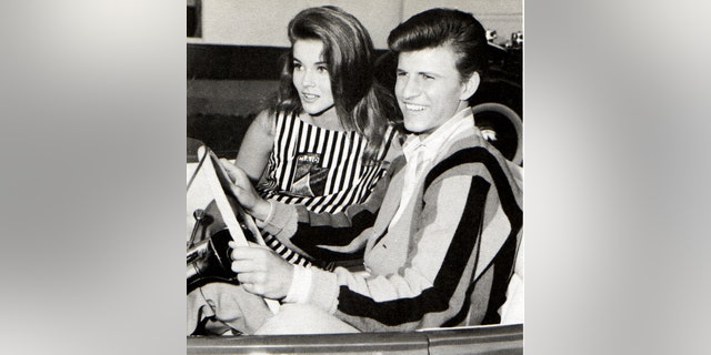 Bobby Rydell riding a car in a striped shirt next to Ann-Margret in a matching striped dress