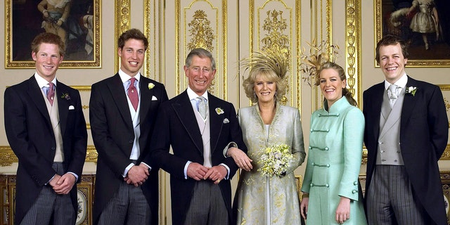 King Charles and Camilla, Queen Consort smiing on their wedding day alongside their children