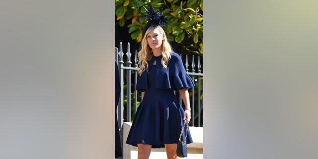 Chelsy Davy wearing a blue dress and matching fascinator