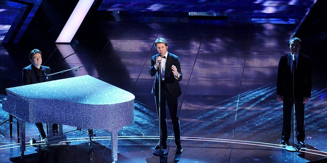 Emanuele Filiberto on stage singing in a tux