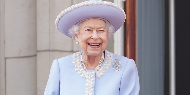 Queen Elizabeth wearing a powder blue dress and pearls
