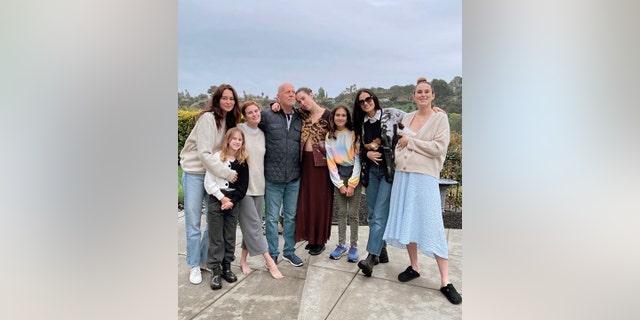 Bruce Willis is surrounded by his family outside on the patio for his birthday, from left Emma, Evelyn, Tallulah, Bruce, Scout, Mabel, Demi, and Rumer