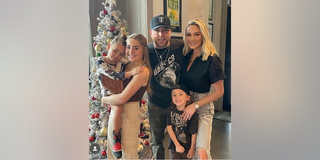 Jason Aldean poses with his children Navy, Memphis and Kendyl with his wife Brittany