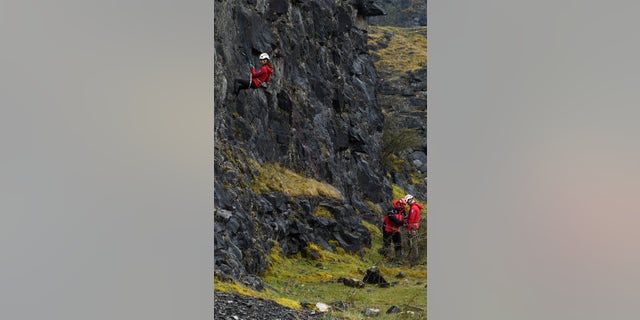 William rappels down a cliff