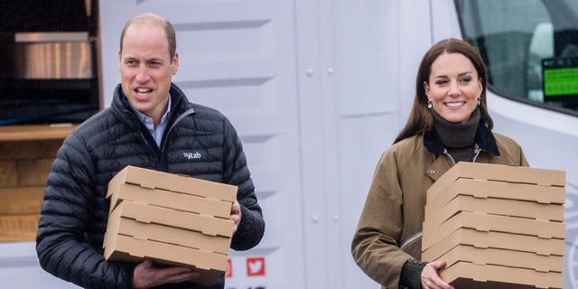 Kate Middleton and Prince William carry pizza
