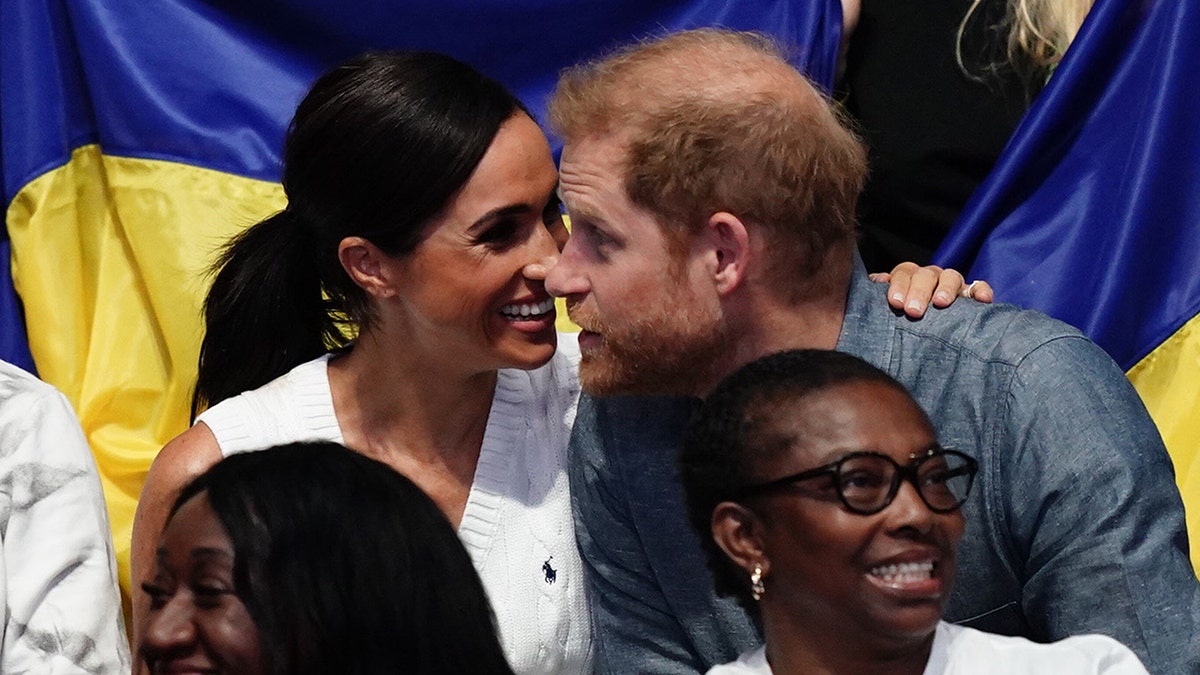 Prince Harry and Meghan Markle talk during Invictus Games