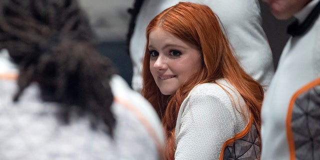 Ariel Winter shows off red hair while wearing white jumpsuit