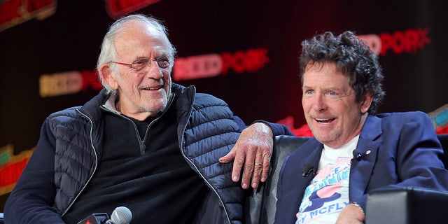 Michael J. Fox and Christopher Lloyd laugh during Back to the Future reunion panel