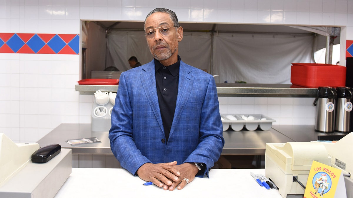 Breaking Bad star Giancarlo Esposito sports blue suit at fast food counter