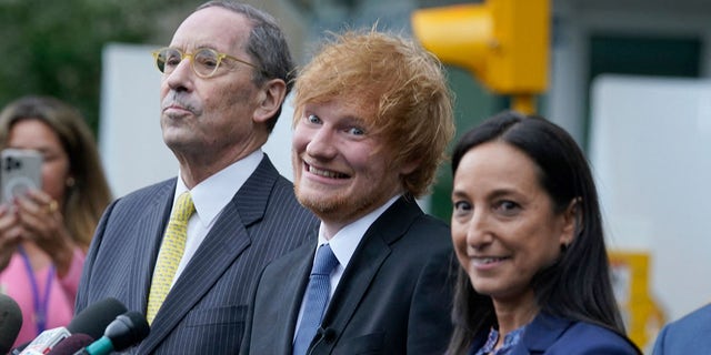 Ed Sheeran wears black suit with blue tie at Manhattan courthouse