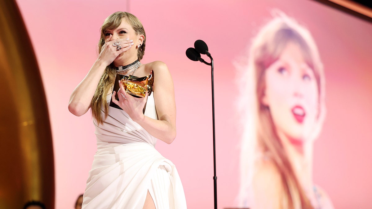 Taylor Swift accepts an award at the Grammys