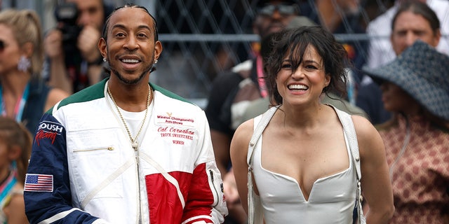 Michelle Rodriguez wears white corset top at Formula 1 race with Ludacris