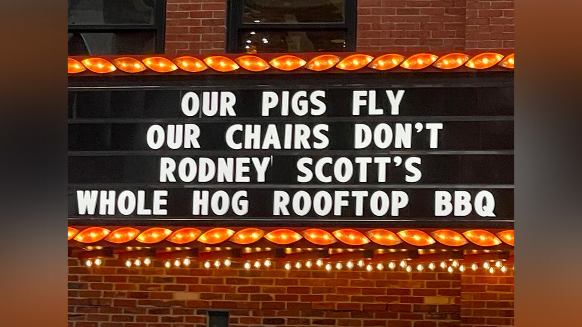 Eric Church's Chief's Bar marquee says "Our pigs fly our chairs don't rodney scott's whole hog rooftop bbq"
