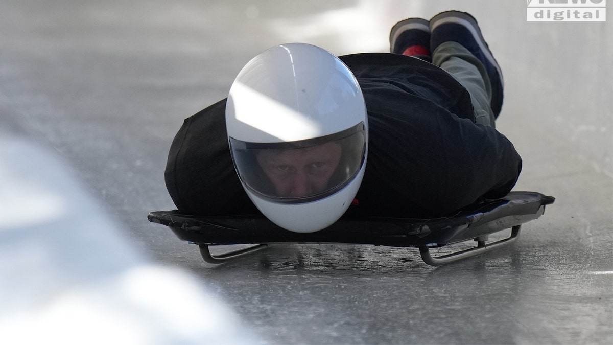 Prince Harry laying on a luge